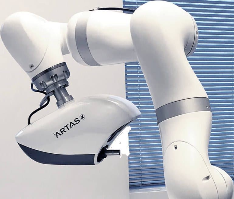 The FDA-cleared ARTAS iX robotic arm used for follicular unit harvesting