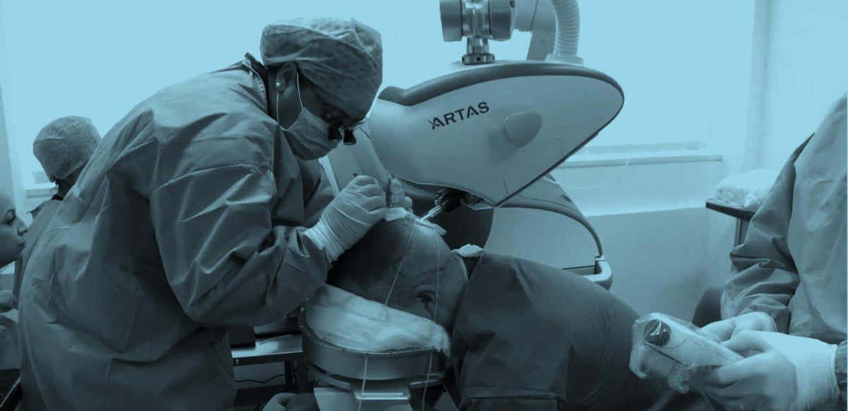 A Hair By Robotics clinician performing an ARTAS robotic hair restoration procedure